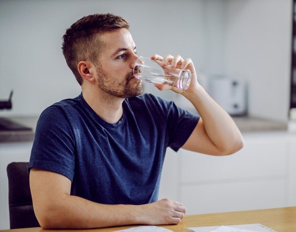 man drinking water before dna test